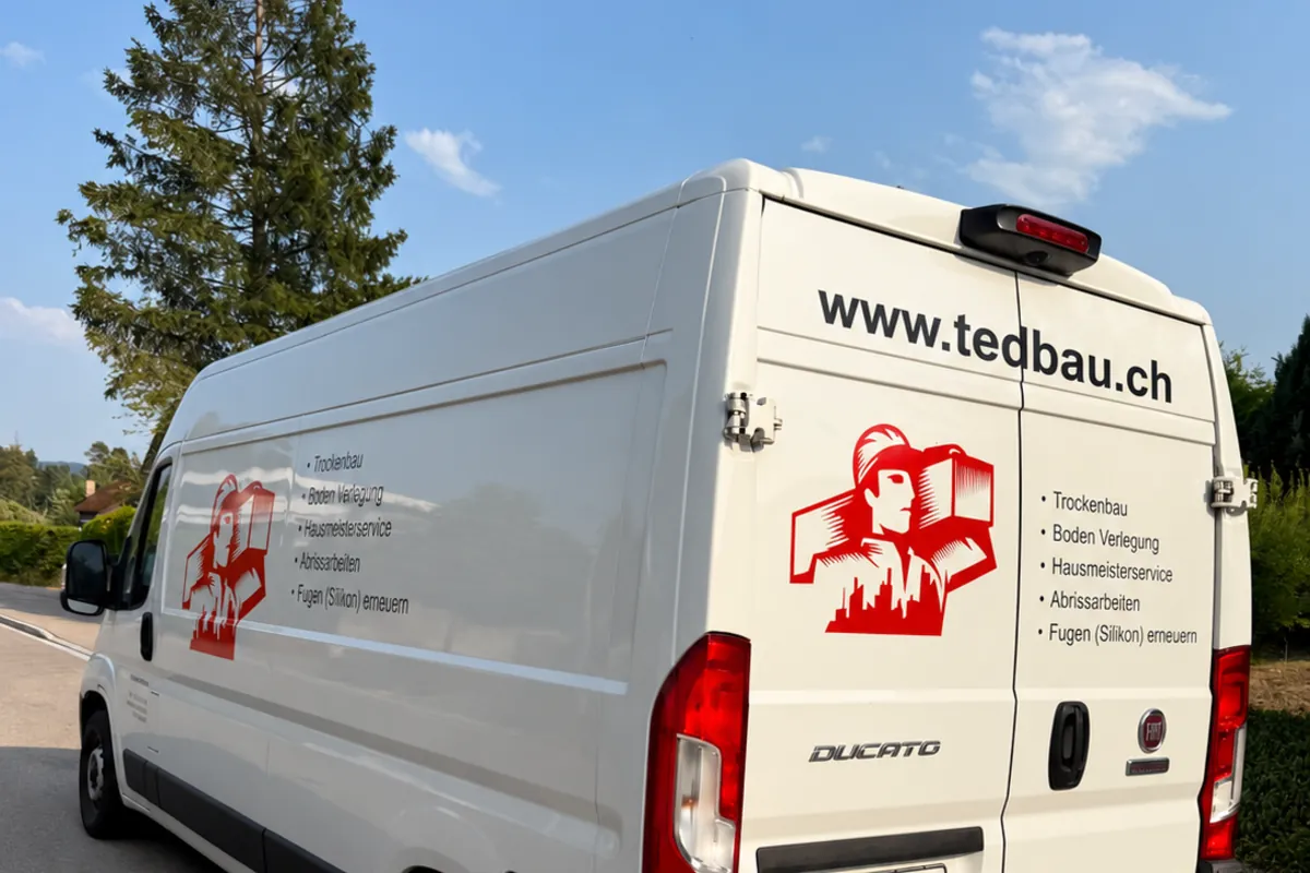 Lieferwagen von TED Bau & Renovation mit Logo, Leistungen und www.tedbau.ch auf der Heckklappe